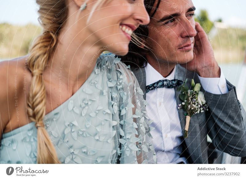 Couple holding hands while sitting on boat groom bride wedding marriage love celebration couple wife woman happiness cheerful embracing hugging relationship