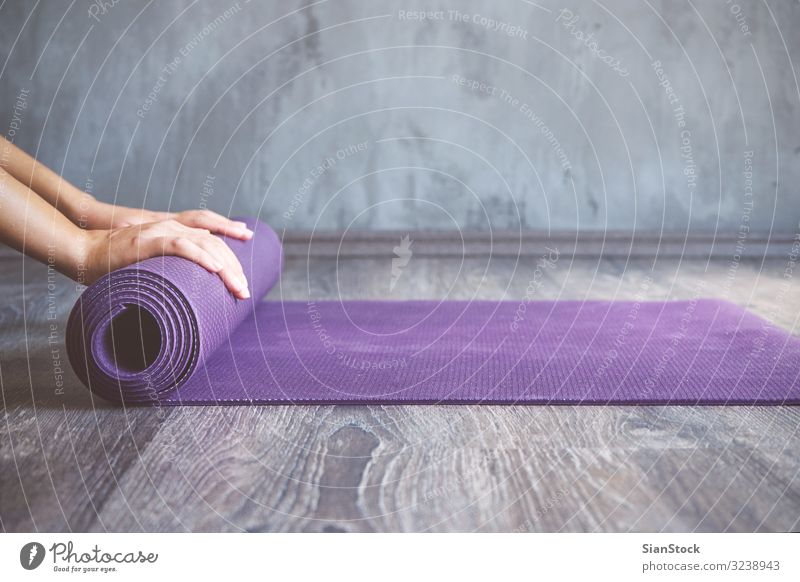 Woman rolling her mat after a yoga class Lifestyle Beautiful Body Relaxation Meditation Sports Yoga Human being Adults Fitness Thin young Practice pose workout