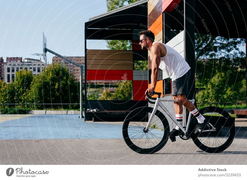 Man riding bike next to buildings man ride bridge city modern active sportive bicycle summer male sunglasses cyclist recreation healthy adventure equipment