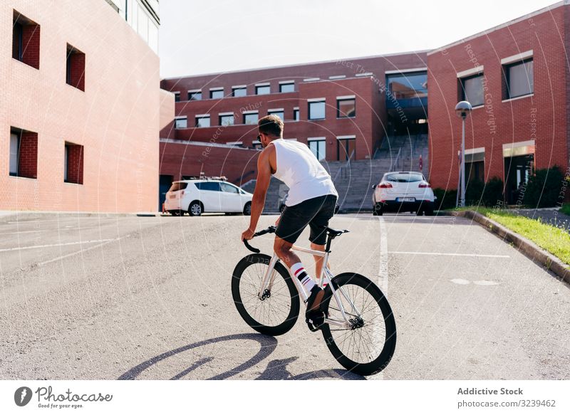 Man riding bike next to buildings man ride bridge city modern active sportive bicycle summer male sunglasses cyclist recreation healthy adventure equipment