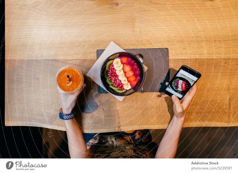 Woman taking photo of fruit bowl with smartphone food table wooden woman juice healthy picture female mobile cellphone image gadget digital shot