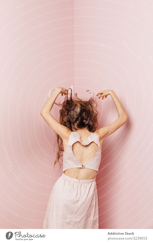 Back view of a young girl telephone wall lamp indoor pink unsatisfied long hair angry passive standing unhappy hair style loss stress haircare bad looking lady