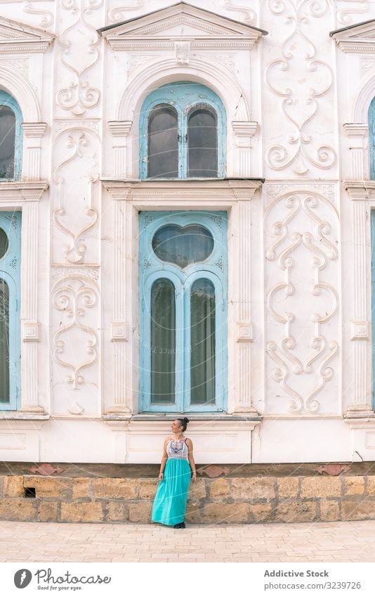 Woman leaving ornamental building tourist traditional woman walk stairs bukhara uzbekistan mausoleum dome architecture travel islamic oriental trip journey old