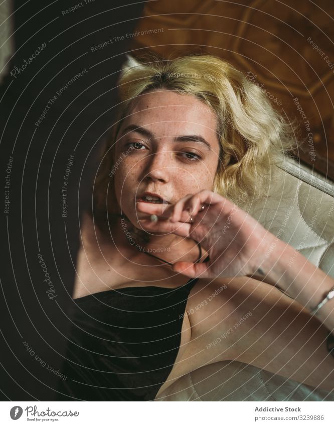 Attentive thoughtful young woman lying in bed and looking at camera contemplate freckle attentive rest pensive dream relax brown eyes watch interest fair hair