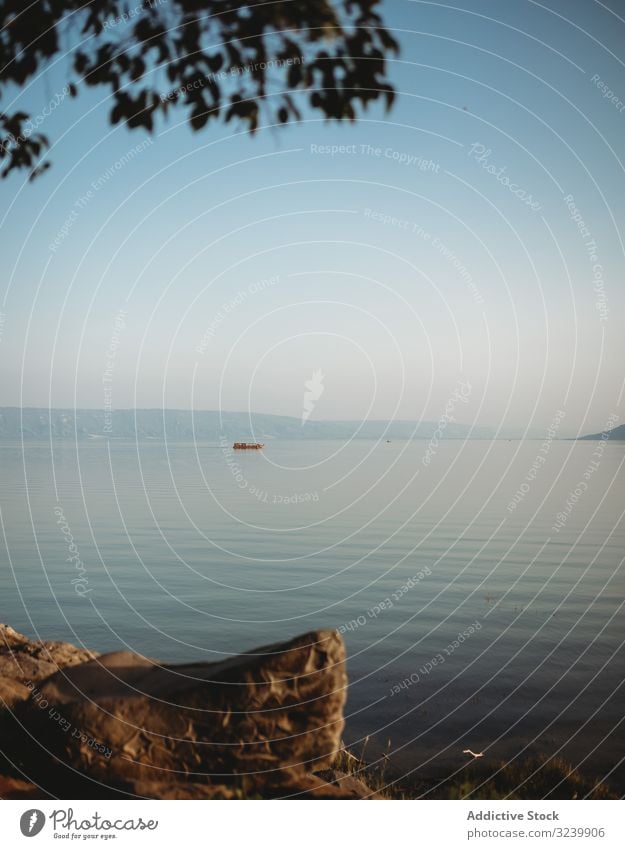 Rippling sea water near shore evening sky ripple calm stone surface cloudless clear tranquil serene peaceful harmony idyllic coast scenic picturesque