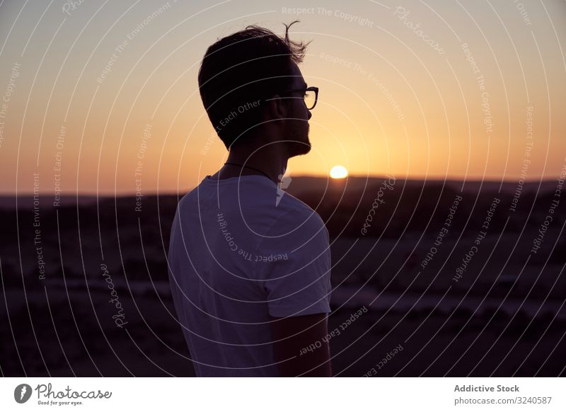 Carefree man standing and enjoying mountain landscape at sunset tourist picturesque sunrise island tenerife spain el teide carefree scenic nature travel sky