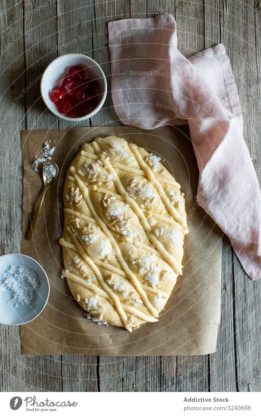 Coca de San Juan on rustic table pastry traditional fresh coca de san juan book recipe knife towel seed food homemade bakery dessert kitchen sweet tasty yummy