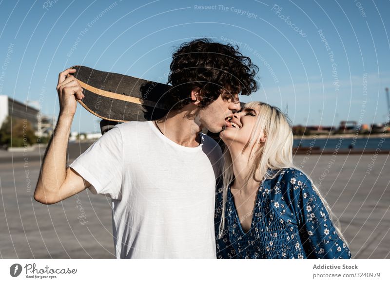 Trendy in love couple hugging on street skateboard embrace amour calm romance boyfriend girlfriend charming romantic effortless relationship confident trendy