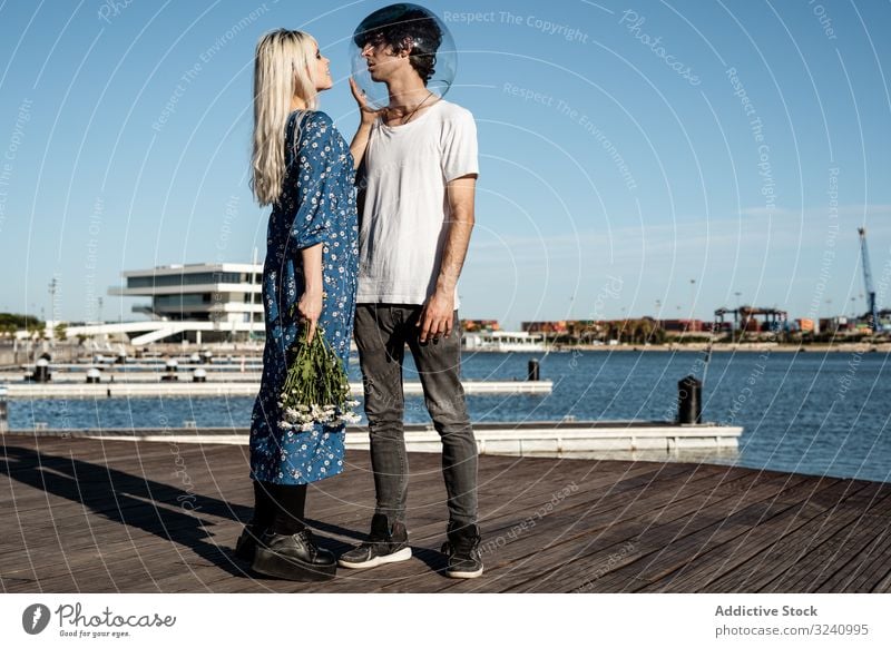 Woman touching fish bowl on head of boyfriend couple crisis relationship concept unhappy introvert serenity silence calm solitude tranquil girlfriend daisy