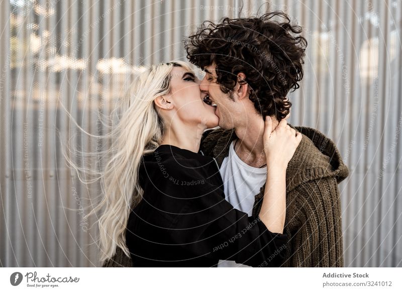 Happy loving couple having fun while kissing on street love cheerful pleasure tongue happy bite soulmate feelings affection trust romance caress boyfriend