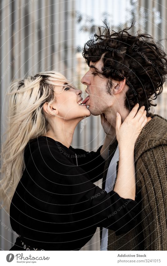 Happy loving couple having fun while kissing on street love cheerful pleasure tongue happy bite soulmate feelings affection trust romance caress boyfriend