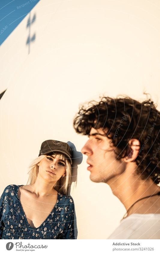 Couple leaning on wall contemplating couple enjoy love sensual pensive curiosity contemplate girlfriend boyfriend gaze interest charming personality dream