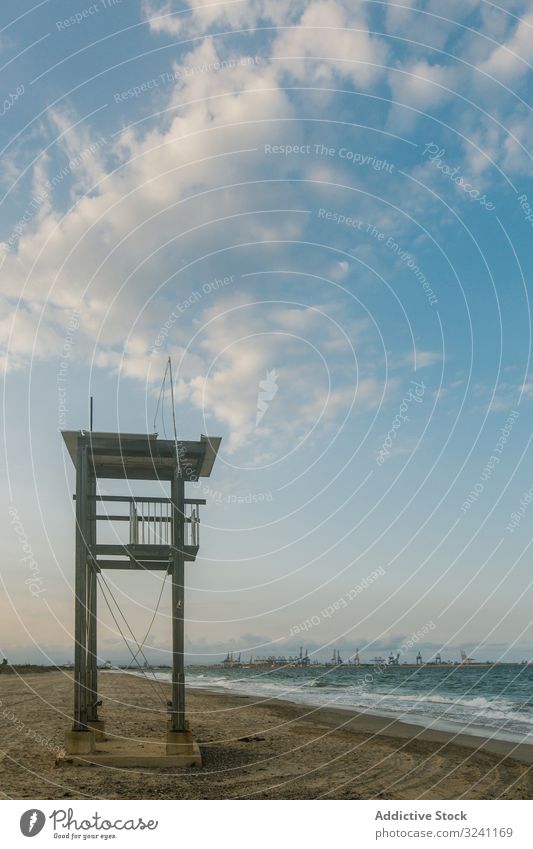 Observation tower at empty seashore observation tower construction lifesaver sand trace beach wheel wave cloudy solitude horizon waterfront ocean rescue