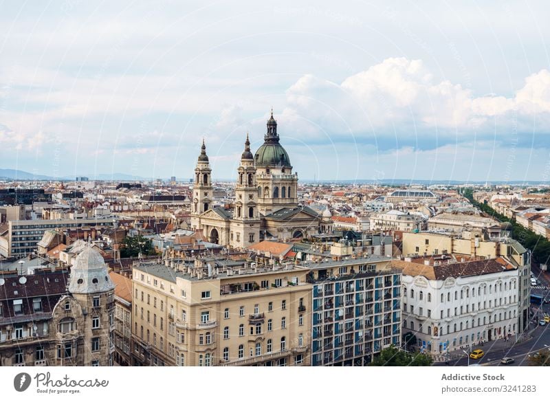 Majestic cathedral over buildings and houses in bright cloudy day cityscape architecture travel budapest geometric tourism hungary church historic old famous