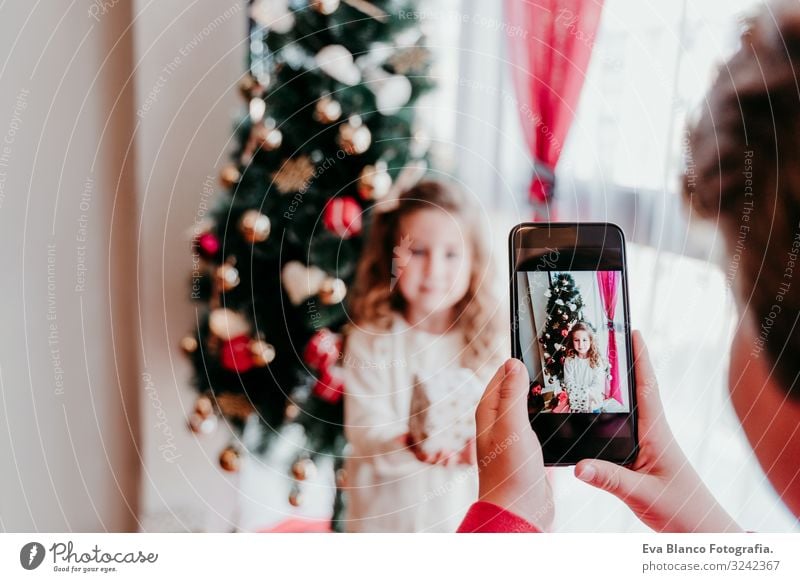 brother taking a picture of his sister with mobile phone Lifestyle Joy Playing Winter House (Residential Structure) Christmas & Advent Cellphone PDA Screen