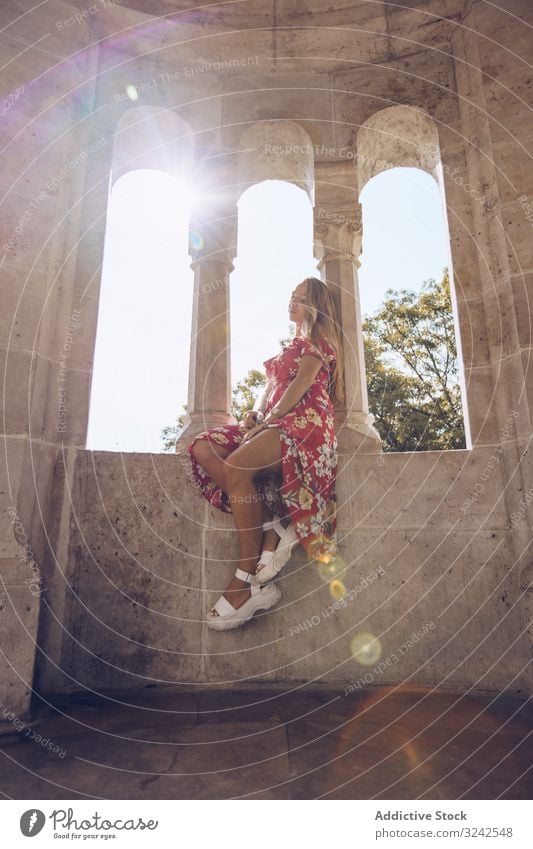 Woman sitting on columned marble fence woman garden city river calm landscape budapest nature alone peace urban building tranquil scenic architecture water