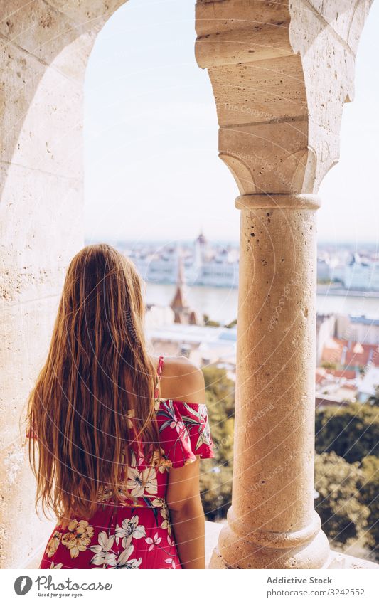 Woman sitting on columned marble fence woman garden city river calm landscape budapest nature alone peace urban building tranquil scenic architecture water