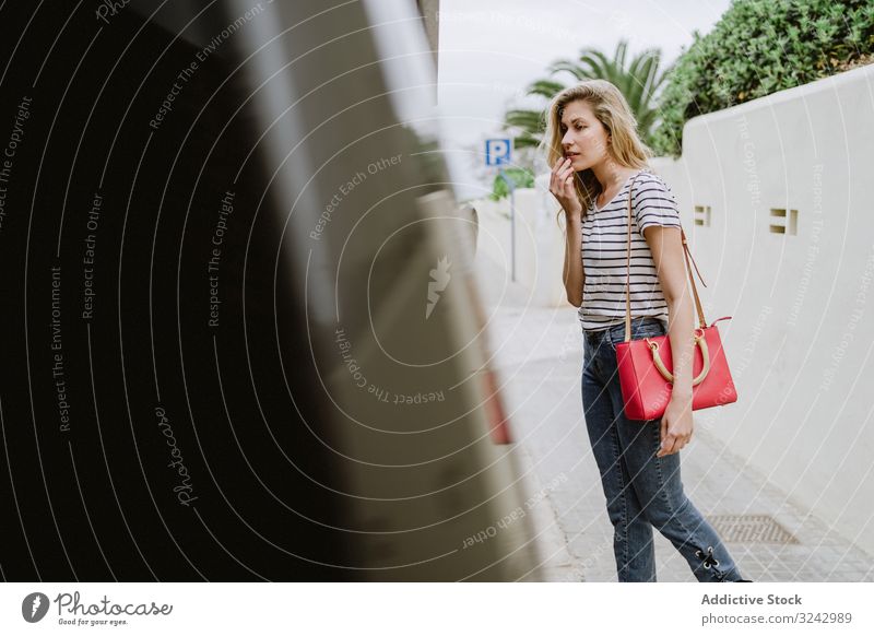 Unsure woman standing next to bus in city unsure indecisive bus stop doubt ask street urban young stylish fashionable female transportation travel waiting