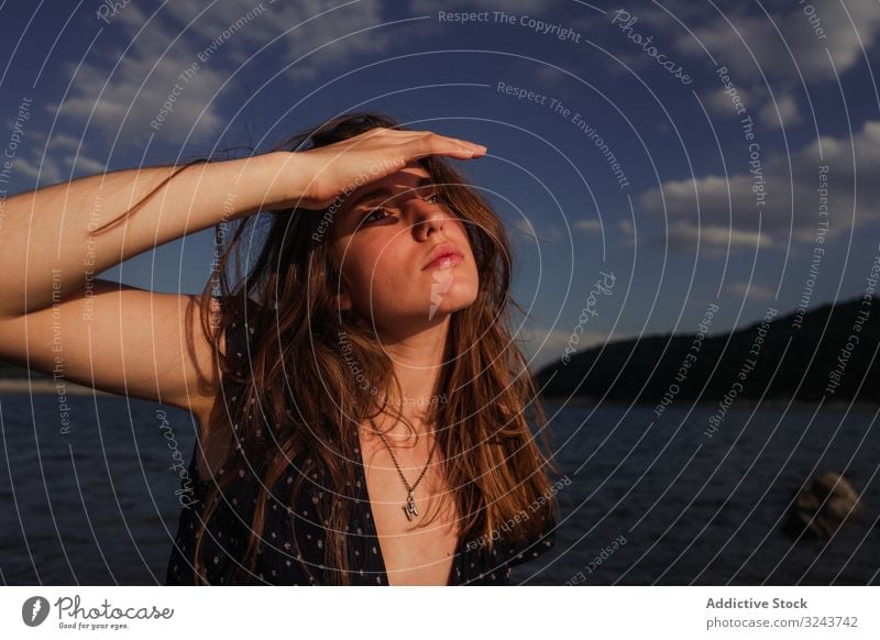 Sensual woman resting on lake shore coast rock sensual summer young dreamy cloudy sky female water vacation weekend lifestyle nature countryside weather lady