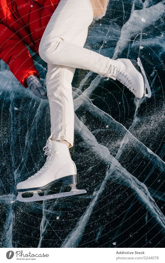 Happy woman in skates lying on ice happy enjoy winter river frozen siberia nature freedom cold russia female young fun adventure activity tourism travel journey