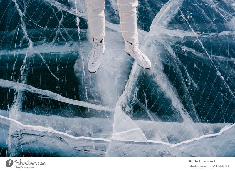 Woman skating on frozen river woman ice winter mountain rock cold siberia activity nature sportswear russia female adventure tourism travel journey trip season