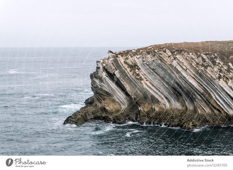 Rocky formations in the island of Baleal on the Atlantic coast in a foggy day. Peniche, Portugal peniche baleal baleal island surf tourism rocks rocky coastline