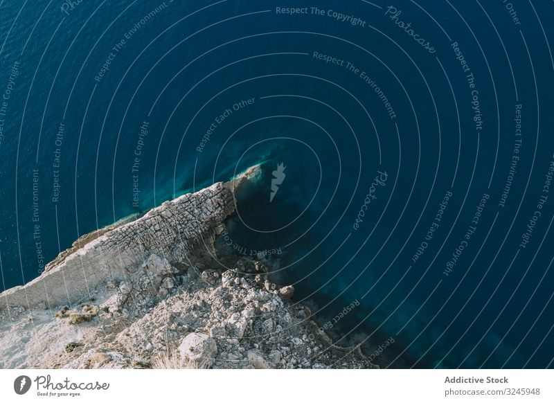 Blue sea waving near stony shore wave storm splash rock weather spain nature water blue rough stone scenic ocean tide coast power energy roll environment foam