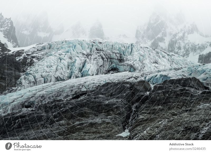 Gray rocky mountains with snow under foggy mist snowy travel nature hiking adventure landscape trekking tourism top hike natural vacation harsh trip scenic