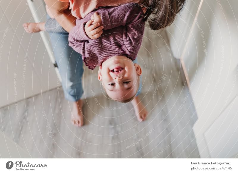 young mother at home playing with her adorable one year old baby girl. family time Lifestyle Joy Happy Beautiful Leisure and hobbies Playing