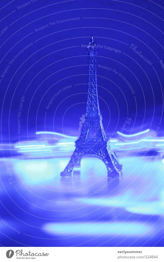 Eiffel Tower between lights in blue and purple paris city paris eiffel tower Tourism Sightseeing City trip Night life Party Going out Technology