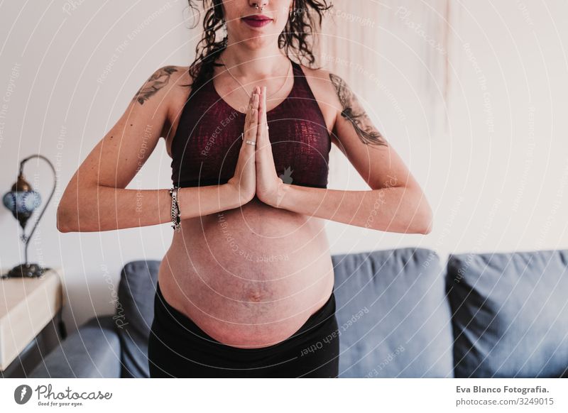 young pregnant woman at home practicing yoga sport. healthy lifestyle Pregnant Woman Yoga Home Sports Healthy Lifestyle Youth (Young adults) Caucasian Parenting