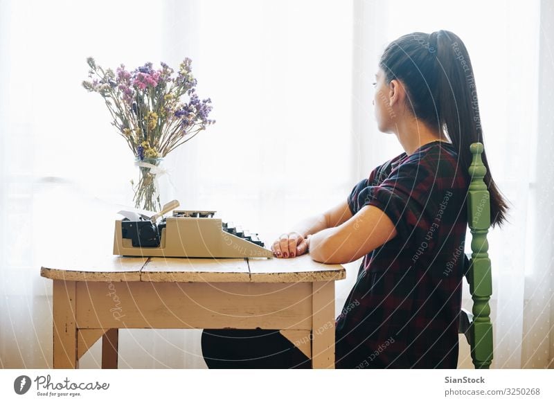 Young woman typing on a vintage typewriter Work and employment Office Hand Paper Metal Old Write Retro Nostalgia Antique Writer background equipment girl