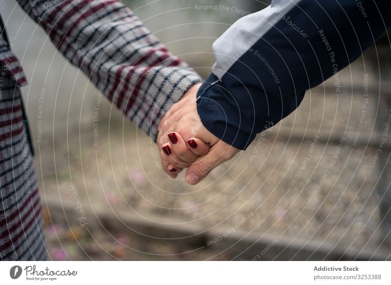 Casual faceless couple holding hands and strolling in city romantic love casual harmony idyllic lifestyle together relationship holiday street albaicin granada