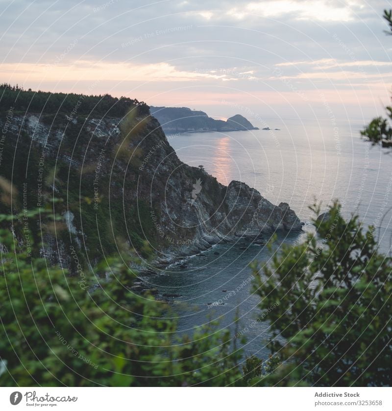 Scenic rocky seascape during sunset rocks bay water nature shore coast picturesque scenic evening rays peaceful marine stone breathtaking sky cliff landscape