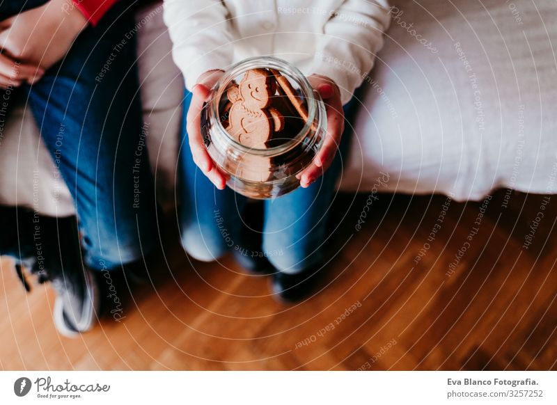 beautiful brother and sister at home having a delicious snack. Girl holding a jar of cookies. Christmas concept Snack Cookie Candy Brother Sister siblings