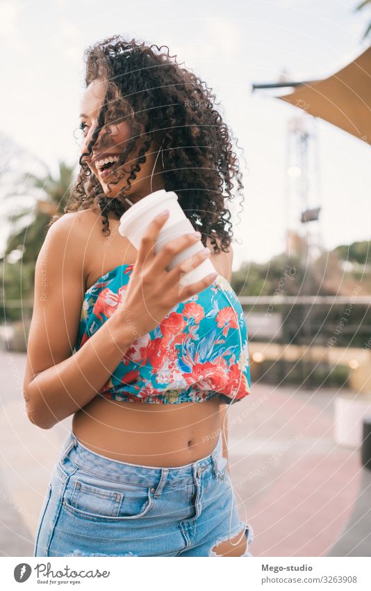 Afro woman listening to music while holding a cup of coffee. Coffee Lifestyle Style Joy Happy Relaxation Music Technology Human being Woman Adults Street