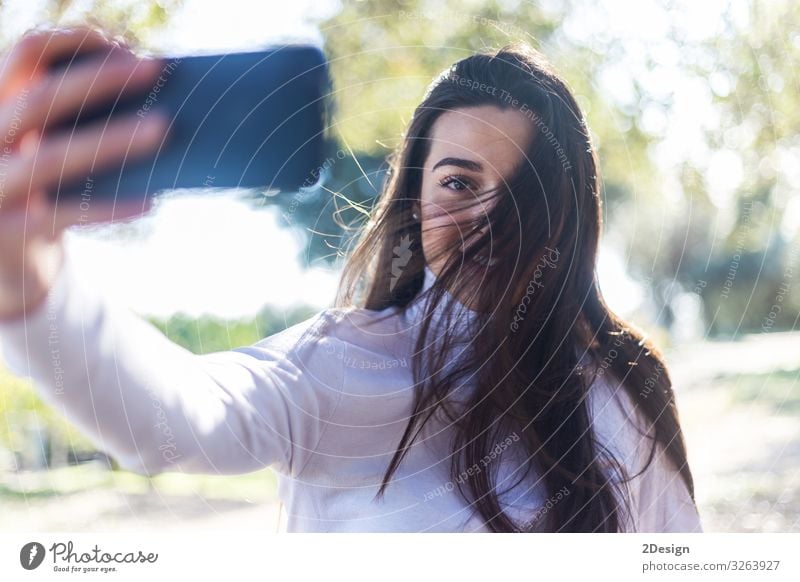 Beautiful young woman selfie in the park Lifestyle Joy Happy Face Telephone PDA Camera Technology Human being Feminine Young woman Youth (Young adults) Woman