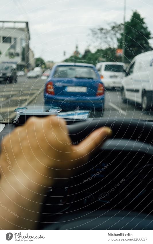 Hand on the steering wheel of a car in traffic Masculine Transport Passenger traffic Motoring Street Car Driving City Europe Maldives Berlin Germany Private