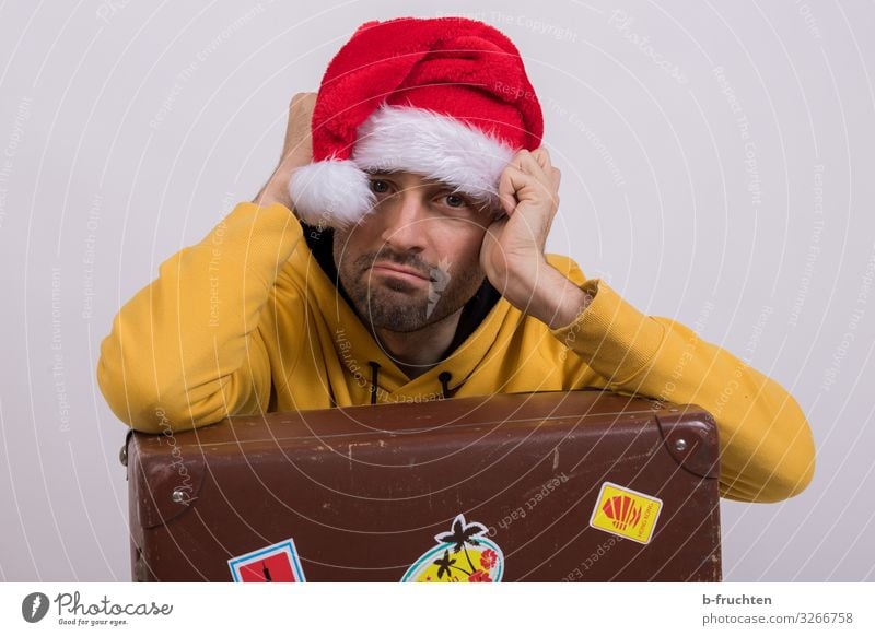 Man with Christmas cap and suitcase Economy Business Adults Face 1 Human being 30 - 45 years Sweater Cap Old Sit Dark Retro Cool (slang) Disappointment Society