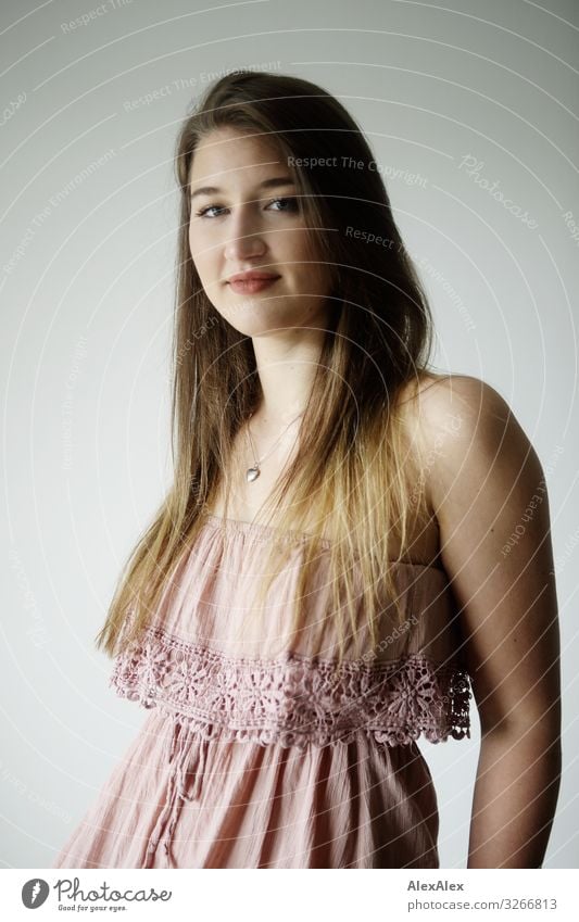 Portrait of a young woman in front of white wall with vignette Lifestyle Elegant Style Joy already Contentment Senses Young woman Youth (Young adults)