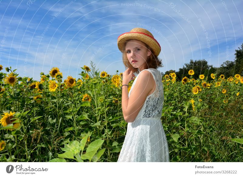 Young girl stands in front of a field of sunflowers Lifestyle Summer Feminine Girl Young woman Youth (Young adults) 1 Human being 13 - 18 years Nature Sky