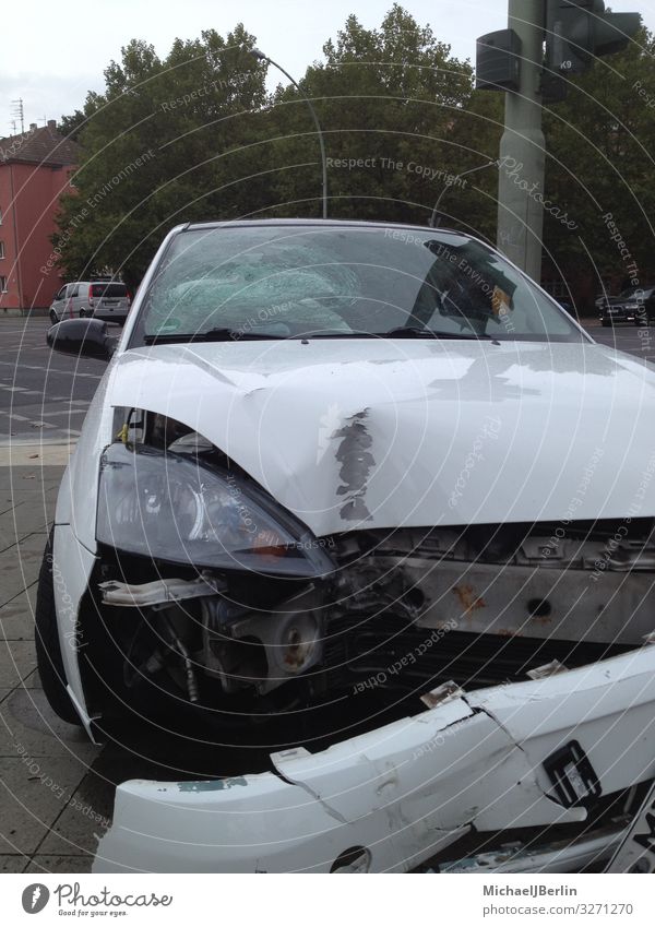 Car with body damage Means of transport Broken White Accident Damage Bodywork damage Fender Light Traffic accident Berlin Town Colour photo Exterior shot Day