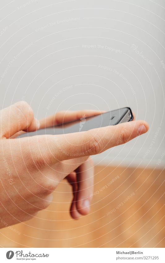 Closeup to hands typing on smart phone, studio indoors shot with teenager man Hands Teenager boy cell phone closeup finger male people person smartphone writing