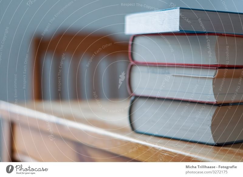 pile of books on the table Leisure and hobbies Reading Education School Study Academic studies Book Think Blue Brown Yellow Orange White Effort Success Table