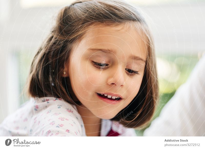 Cute little girl playing game smile involved participation fun happy child childhood kid cute adorable dark hair joyful cheerful sit creative learn interesting