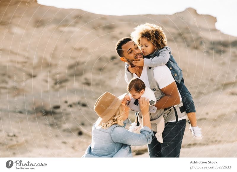 Diverse family having fun on vacation nature parenthood children smile happy cheerful lifestyle modern husband bonding love tender casual kid black multiethnic