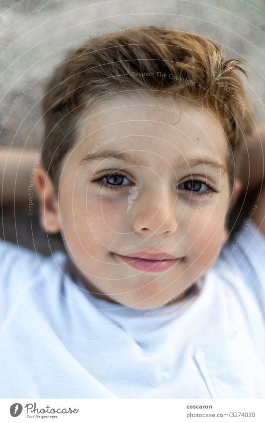 Close up of a cute boy lying Lifestyle Joy Happy Beautiful Face Relaxation Leisure and hobbies Vacation & Travel Summer Beach Child Human being Masculine