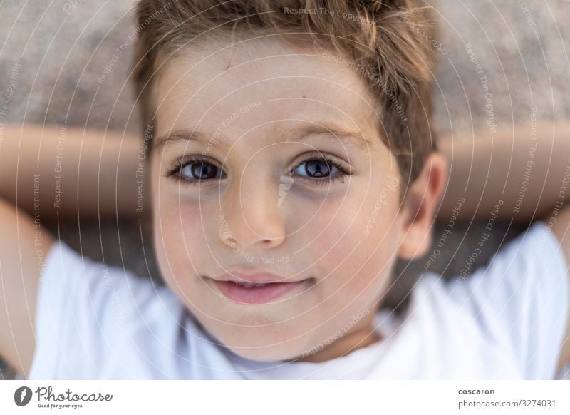 Close up of a cute boy lying down on the beach Lifestyle Joy Happy Beautiful Face Relaxation Calm Playing Vacation & Travel Summer Beach Child Human being