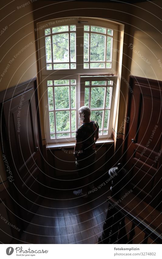 Man at the window Staircase (Hallway) View from a window Window frame Train window Human being Adults 1 Observe Think Looking Stand Wait Curiosity Brave Calm