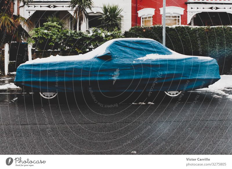 A car with a blue cover under the snow in a London street Climate Ice Frost Snow Vehicle Car Vintage car Kitsch Natural Above Accuracy Cold Moody Town